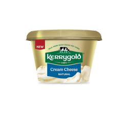 Pack shot of a Kerrygold Cream Cheese Natural tub on a plain background, featuring a gold container with green Kerrygold logo, new label, and text highlighting natural cream cheese made with milk from Irish grass-fed cows.