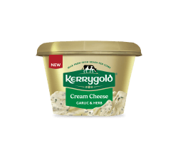 Pack shot of a Kerrygold Cream Cheese Garlic & Herb tub on a plain background, featuring a gold container with green Kerrygold logo, new label, and text highlighting natural cream cheese made with milk from Irish grass-fed cows.