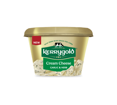 Pack shot of a Kerrygold Cream Cheese Garlic & Herb tub on a plain background, featuring a gold container with green Kerrygold logo, new label, and text highlighting natural cream cheese made with milk from Irish grass-fed cows.